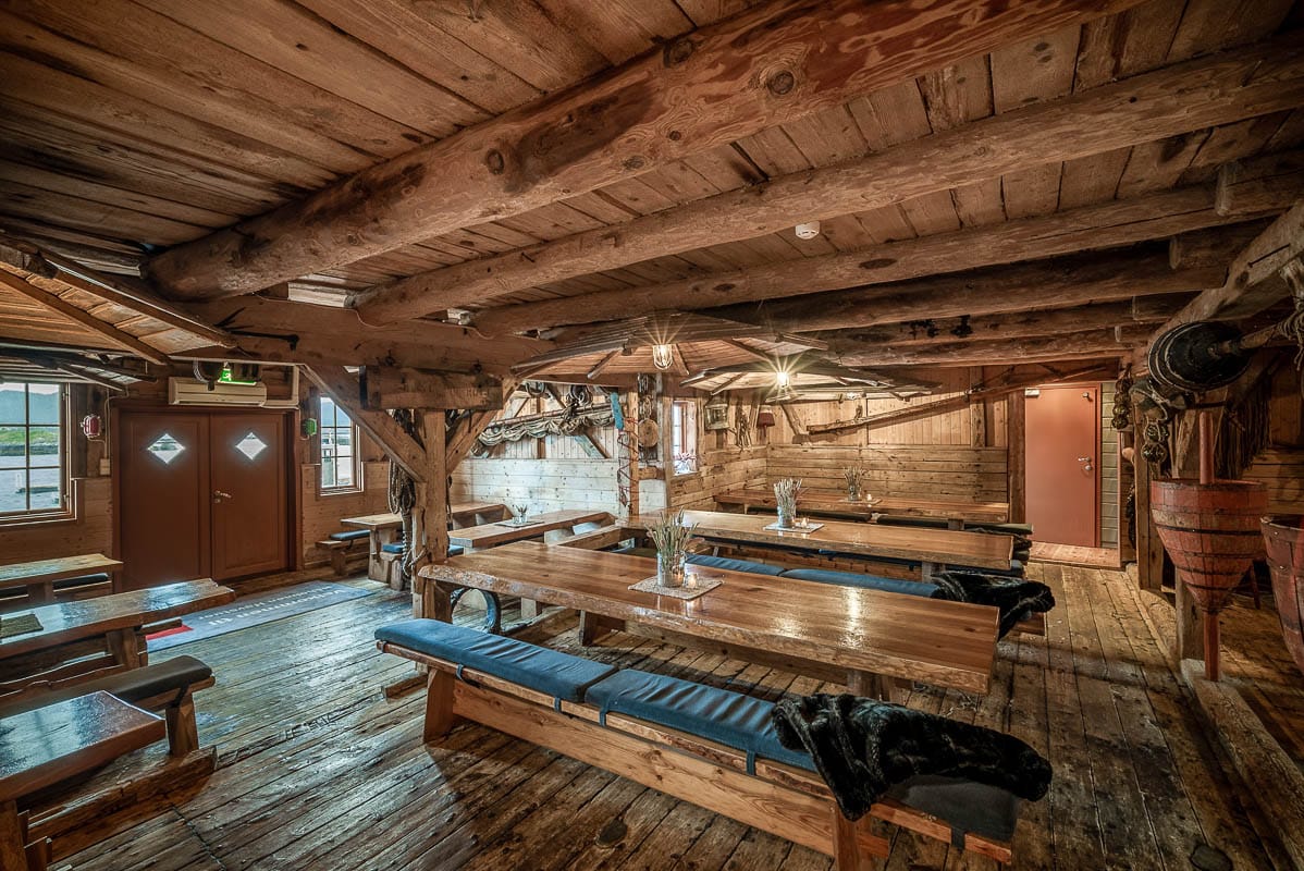 Silver Bell Kro – long tables and timber interior in a historic coastal setting.